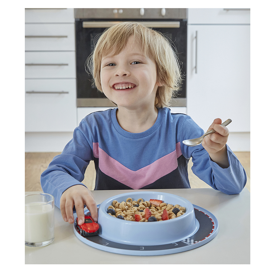 Young boy eating breakfast smiling