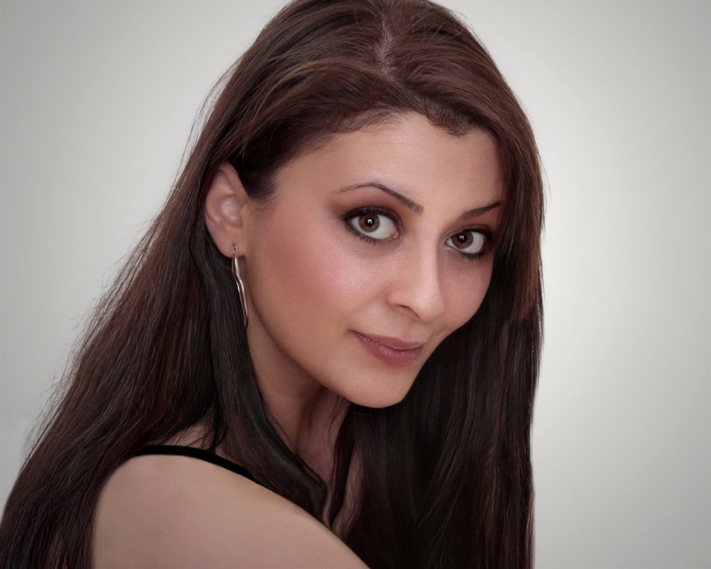 Young lady with dark hair looking over her shoulder