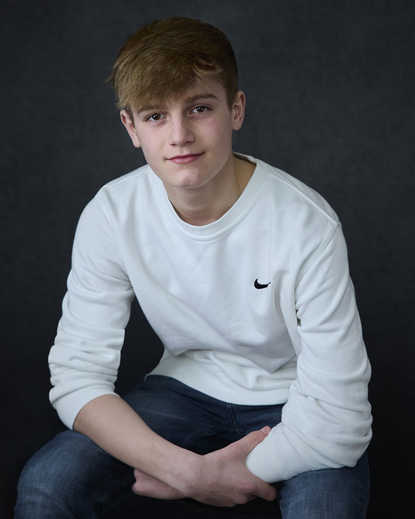 Teenage boy wearing white top modeling for his actor headshots